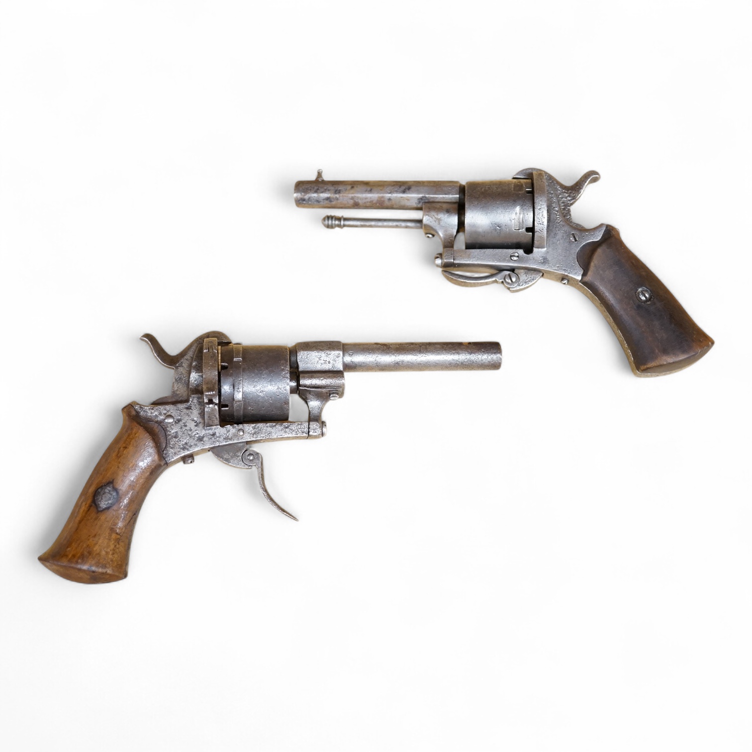 A six shot 7mm Belgian pinfire revolver and another similar, both with folding triggers and wooden grips